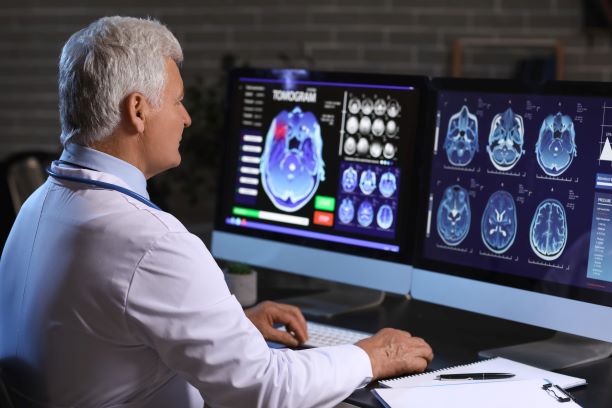 Neurologist evaluating brain scan of patient