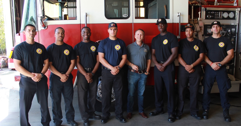 Fireman at firehouse - men lined up next to truck