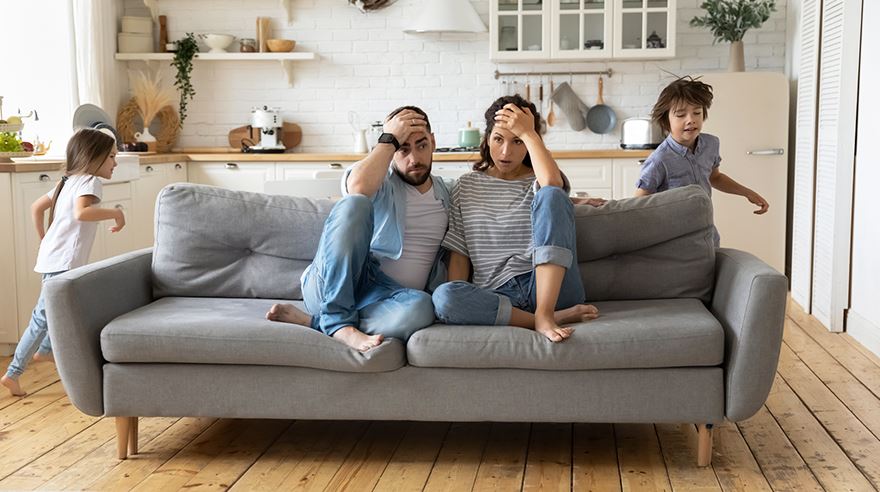 mom and dad on couch frustrated at home