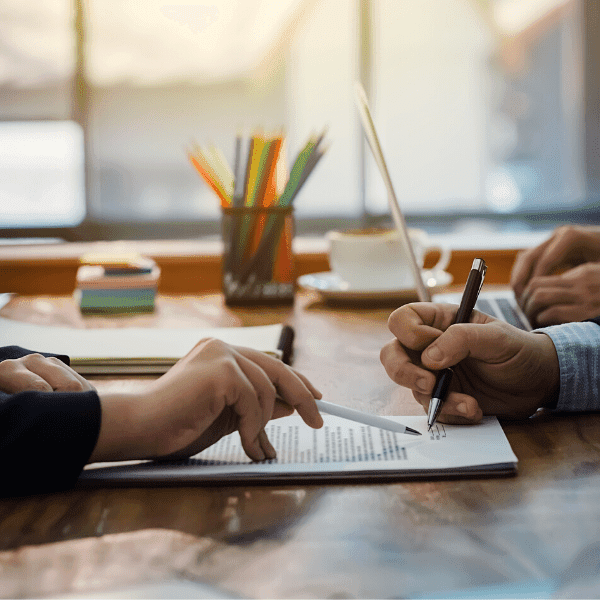 2 people signing workers' comp paperwork