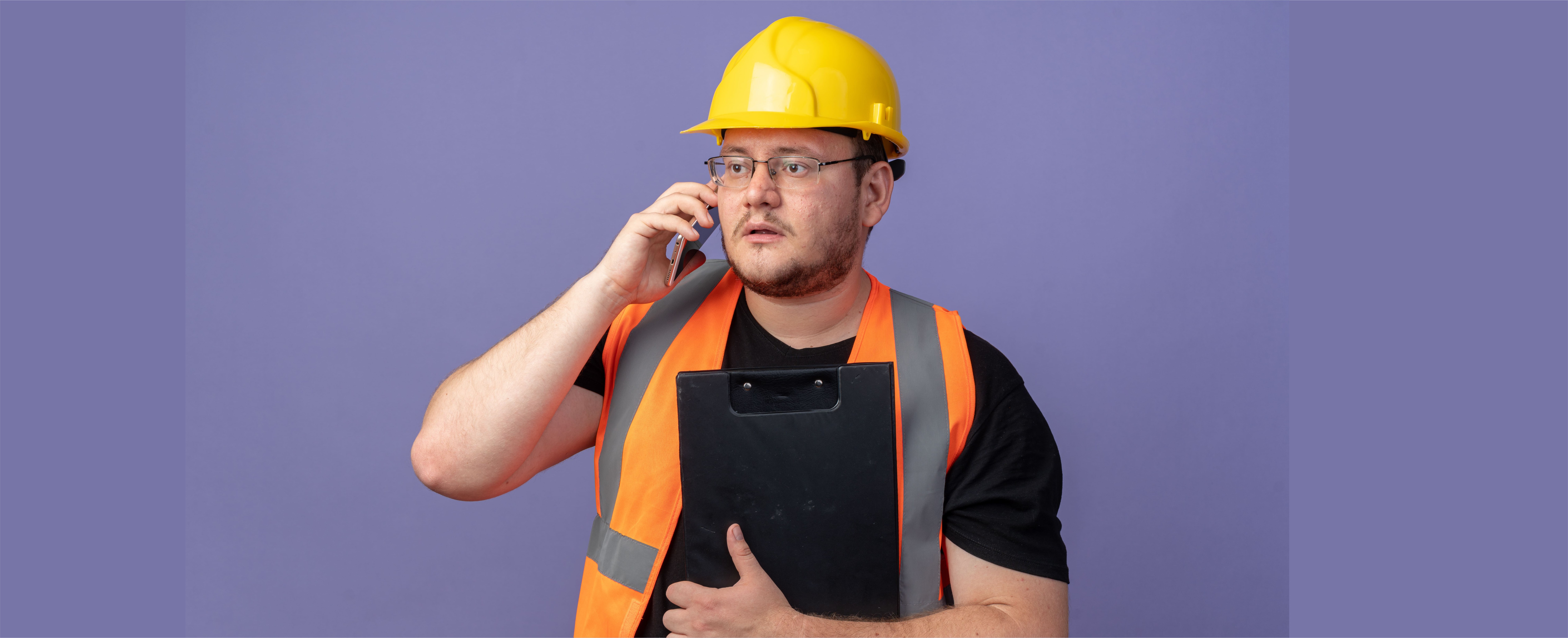 builder-man-holding-clipboard-looking-worried-on-adjuster-phone-call