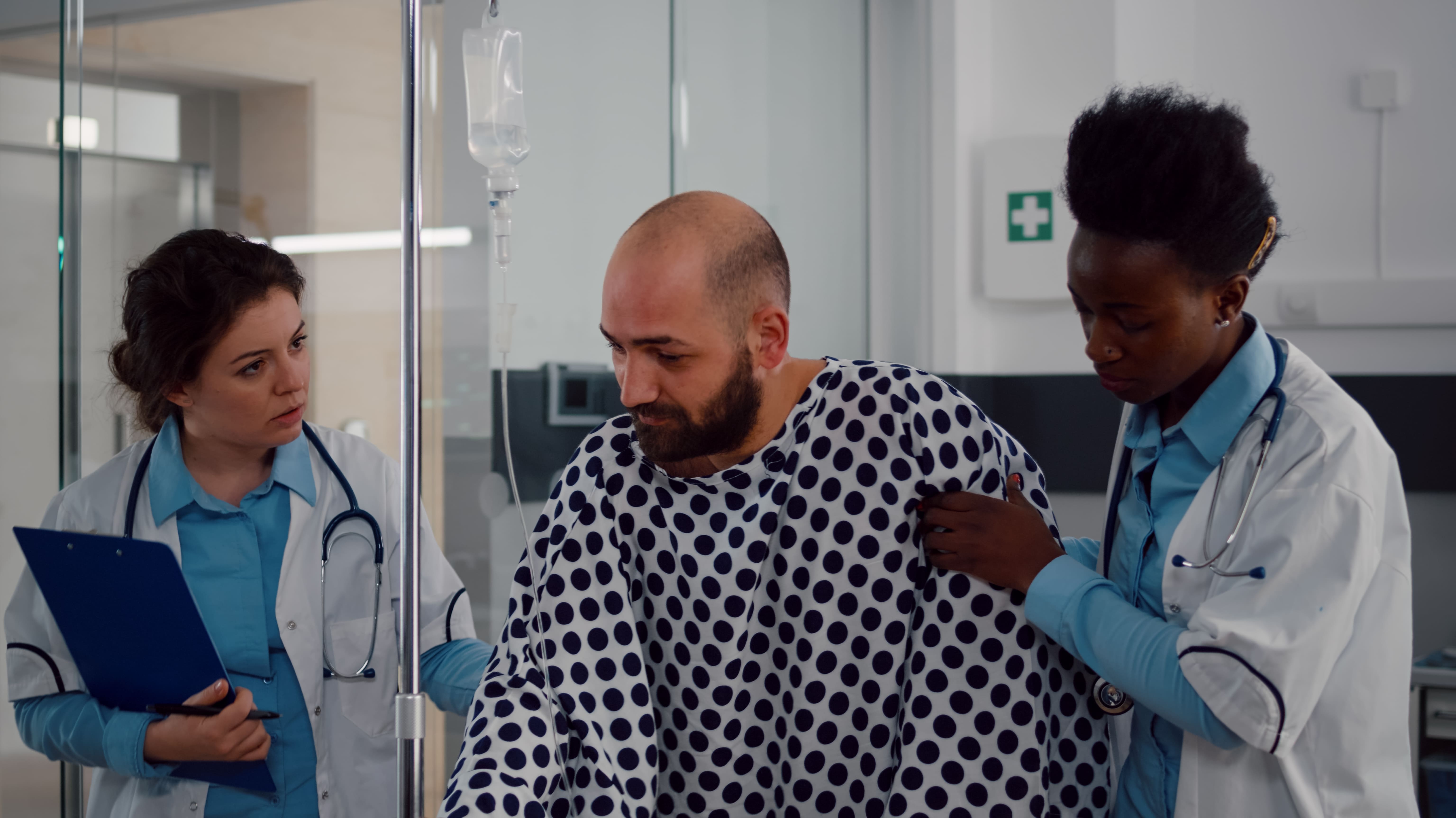 doctors-helping-patient-stand-up-from-bed-as-maximum-medical-imporvement