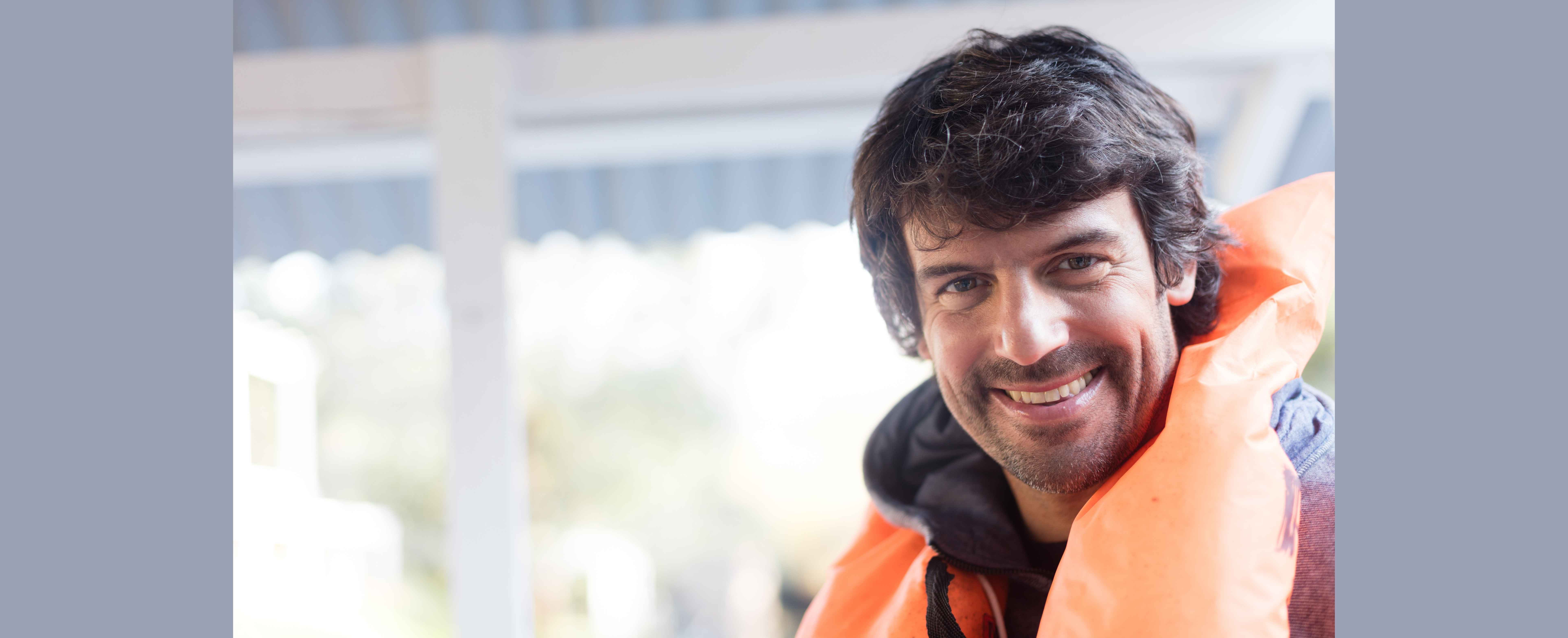 Injured worker smiling because knows how protecting his workers’ comp settlement