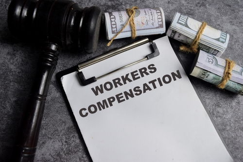 Concept of Workers compensation write on paperwork isolated on Wooden Table.